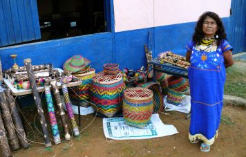 The caciques (chieftains) wife offers handcrafts